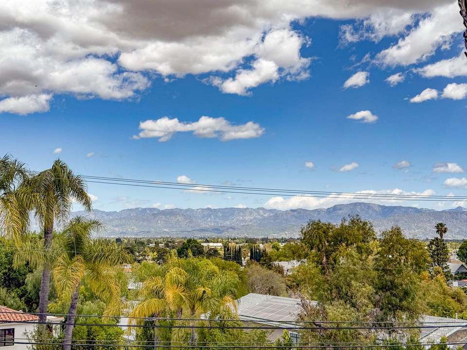 Valley and mountain view over palm trees from an upstairs bedroom window