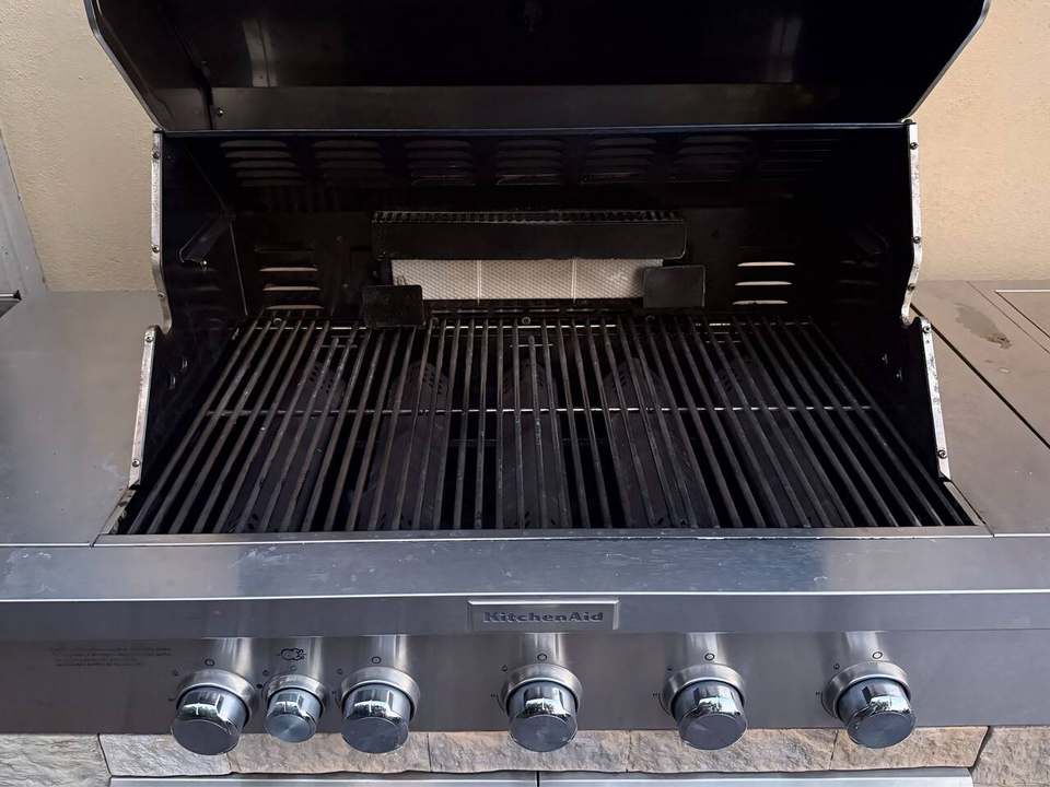 Close-up of the grill's five main burners and control knobs